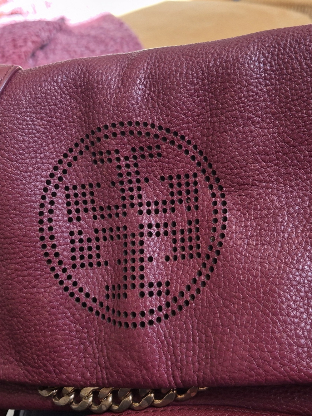 Tory Burch foldover crossbody bag featuring a perforated double-T logo